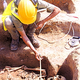 An archaeologist examines the intact remains of a spooky “skeleton person.”